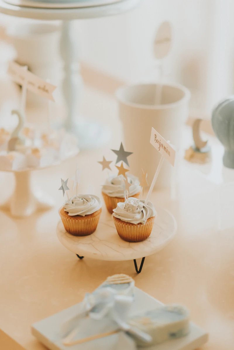 Cupcakes with small paper stars on a cream cake stand