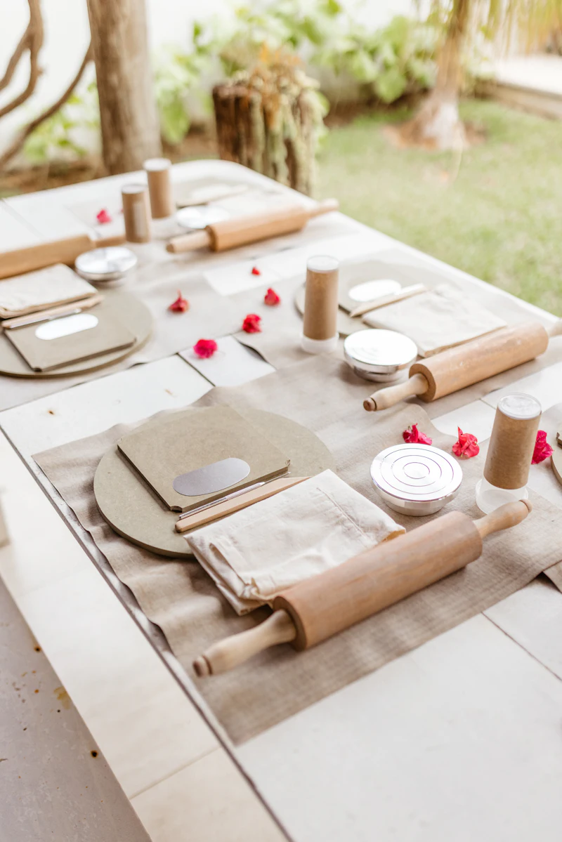 A party table laid with kraft paper, small dishes and wooden tools