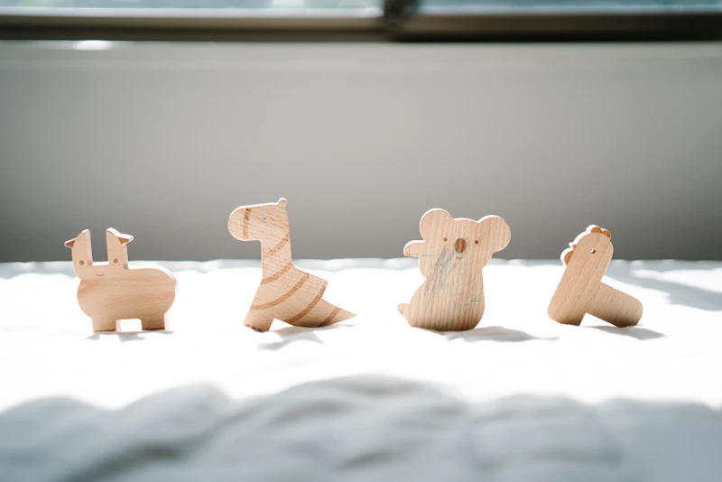 Wooden animals standing on a linen sheet